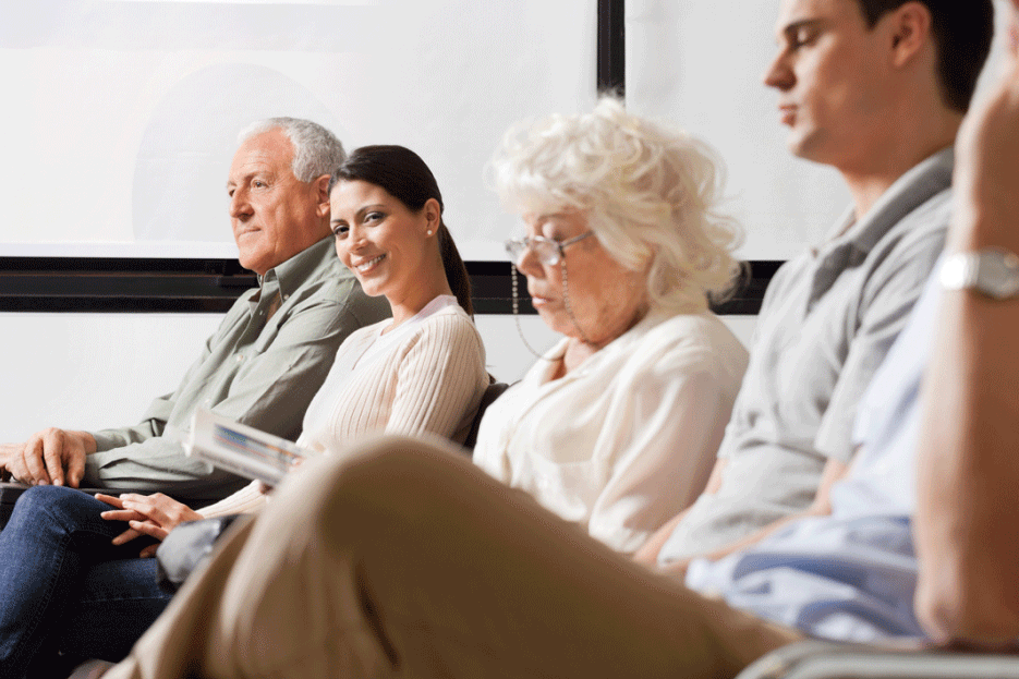 Patients seated whilst waiting in hospital lobby